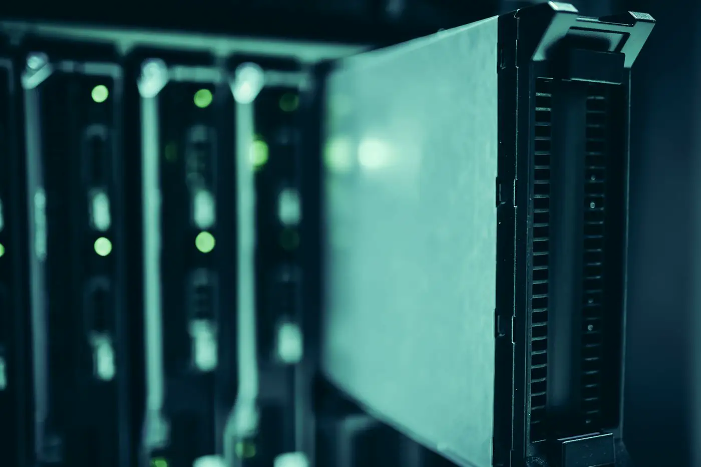 A server module in a rack, with status lights on the equipment behind it